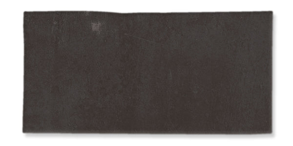 A rectangular, dark gray slate tile with a slightly uneven surface and rough edges, displayed against a white background.