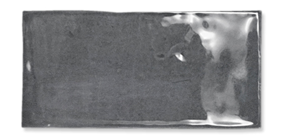 A rectangular, silver-colored metallic ingot with a smooth, slightly reflective surface is shown against a white background.
