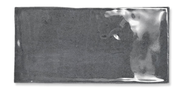 A rectangular, silver-colored metallic ingot with a smooth, slightly reflective surface is shown against a white background.