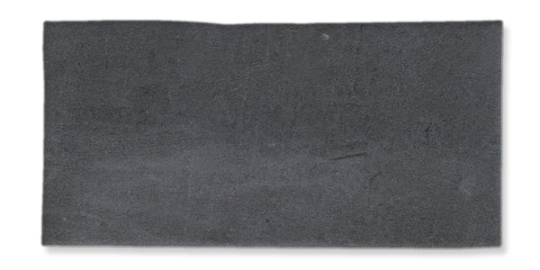 A rectangular slab of dark gray concrete or stone with a slightly uneven surface, viewed from above against a white background.