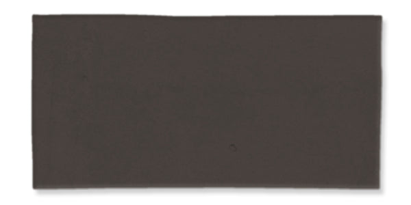 A rectangular, solid dark gray-black tile with a smooth surface and slightly uneven edges, set against a white background.