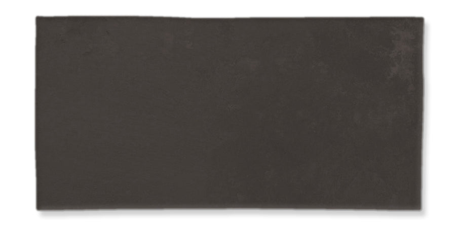 A rectangular, dark gray tile with a slightly uneven surface and subtle texture, set against a white background.