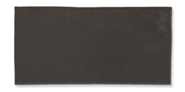 A rectangular, dark gray tile with a slightly uneven surface and subtle texture, set against a white background.