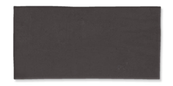 A large, rectangular, dark gray tile with a smooth, matte finish, set against a white background.
