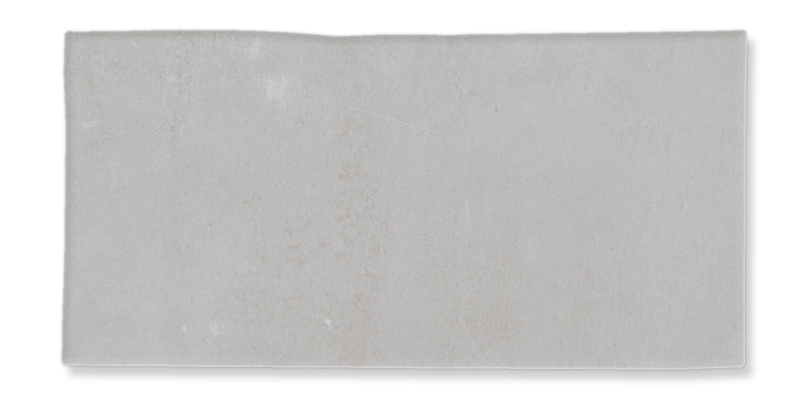 A rectangular, light gray, textured slab or tile with slightly uneven edges on a white background.