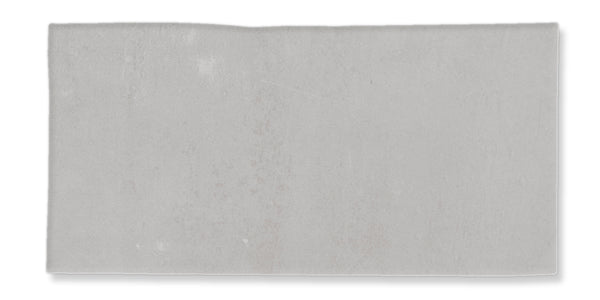 A rectangular, light gray, textured slab or tile with slightly uneven edges on a white background.