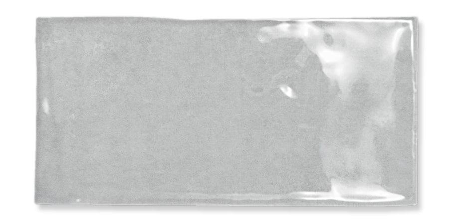 A rectangular, clear plastic sleeve or pouch with a glossy surface, laying flat against a white background. The sleeve appears empty and has slight reflections and creases.