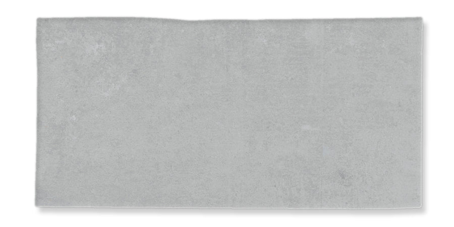 A rectangular, light gray concrete slab with a slightly uneven top edge and a smooth surface.