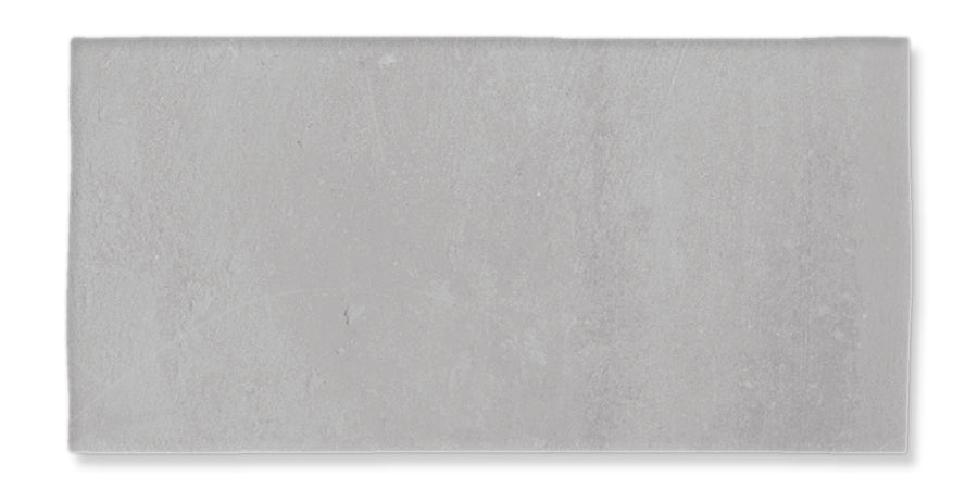 A rectangular, light gray concrete tile with a slightly textured surface, shown against a white background.