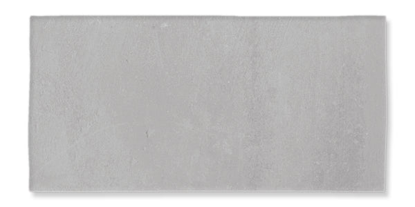 A rectangular, light gray concrete tile with a slightly textured surface, shown against a white background.