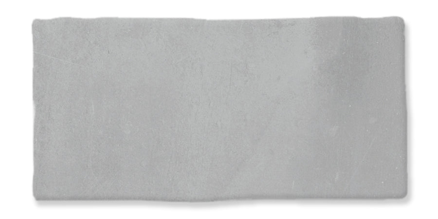A rectangular, light gray concrete tile with a slightly rough texture and subtle surface variations, set against a white background.