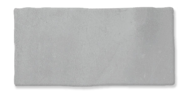 A rectangular, light gray concrete tile with a slightly rough texture and subtle surface variations, set against a white background.
