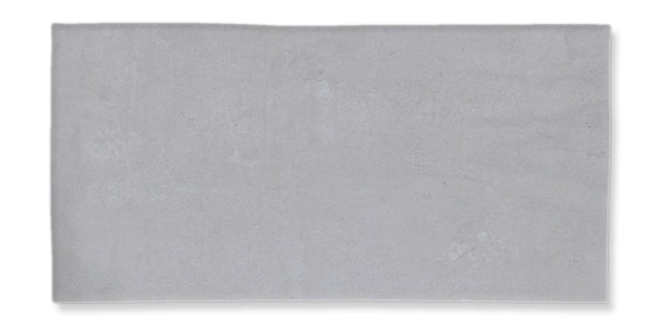 A rectangular, light gray tile with a smooth, matte surface and slightly uneven edges, displayed against a white background.