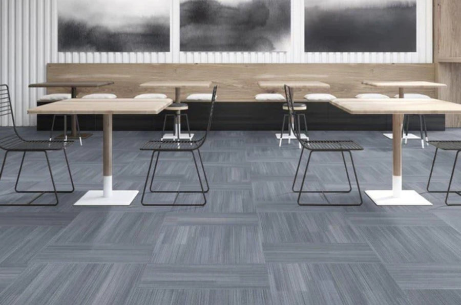 A room with tables and chairs featuring Commercial Modular Carpet Tiles, perfect for any commercial space.