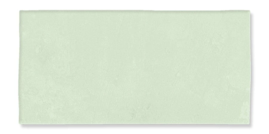 A rectangular, pale green tile with a smooth, matte surface and slightly uneven edges, set against a white background.