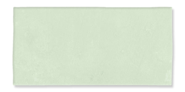 A rectangular, pale green tile with a smooth, matte surface and slightly uneven edges, set against a white background.