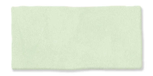 A rectangular, light green textured brushstroke on a white background.