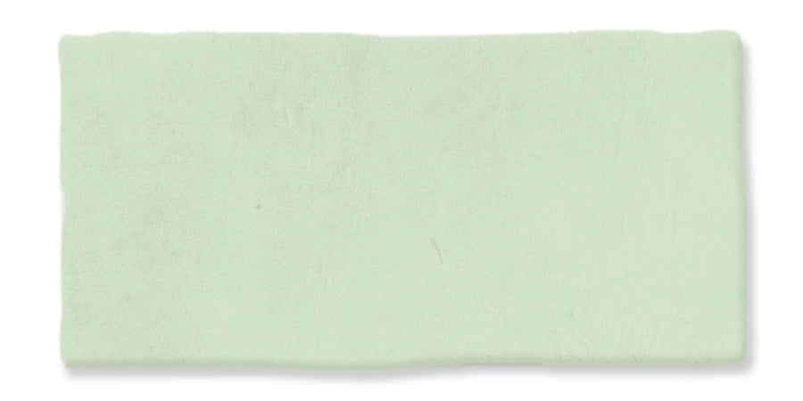 A rectangular, pale green clay bar with a smooth, slightly uneven surface is displayed against a white background.