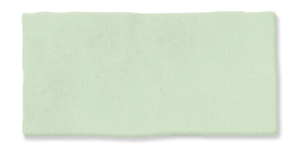 A rectangular, pale green clay bar with a smooth, slightly uneven surface is displayed against a white background.