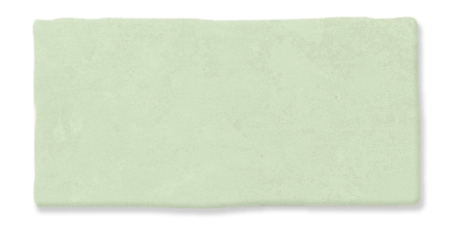 A rectangular, light green tile with a slightly uneven, textured surface and softly irregular edges.