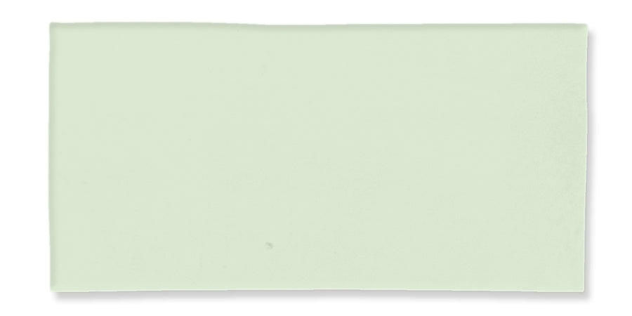 A rectangular, pale green ceramic tile with smooth edges and a slightly glossy surface, placed against a white background.