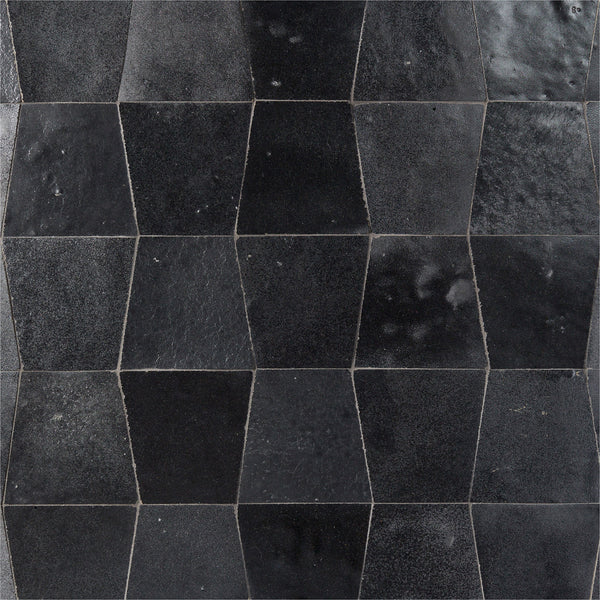 Mistral Trapezoid 3x4 Tile features a black, glossy finish and a unique distorted hexagon shape, creating an elegant, three-dimensional effect with dynamic shades of black and dark gray when arranged in a repeating pattern.