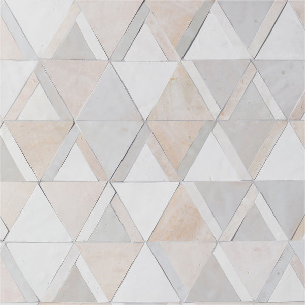 The Mistral Kilim Mosaic features light-colored marble tiles in a geometric triangle pattern, forming hexagons with shades of white, beige, and light gray for a sophisticated look.