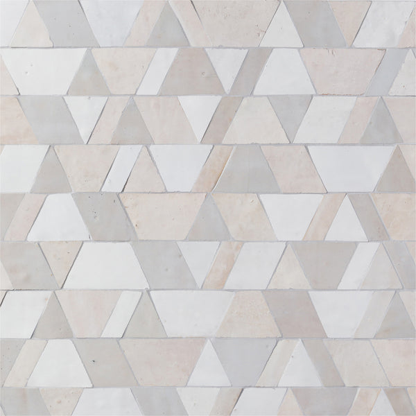 Elevate your space with the Mistral Reverie Mosaic, featuring a geometric pattern of white and light beige tiles in alternating rows of triangles and trapezoids for a refined, textured look.