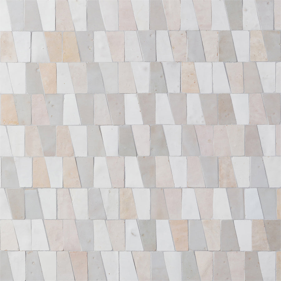 The Mistral Trapezium Mosaic features rectangular and trapezoidal tiles in white, beige, and light gray, offering a sophisticated geometric design ideal for elevating modern home decor.