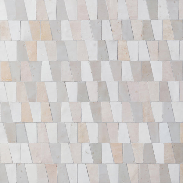 The Mistral Trapezium Mosaic features rectangular and trapezoidal tiles in white, beige, and light gray, offering a sophisticated geometric design ideal for elevating modern home decor.