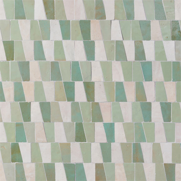 The Mistral Trapezium Mosaic features tiles in green, cream, and white shades, arranged in a repeating staggered pattern for an elegant luxury mosaic effect—ideal for sophisticated home decor.