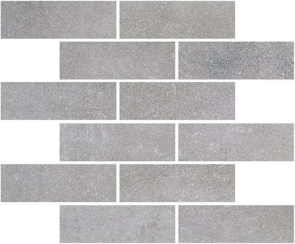Ardennes Interlocking Mosaic Tile in Cliff features rectangular gray tiles with a subtle, textured surface and shade variations, arranged in an offset brick pattern on a white background.