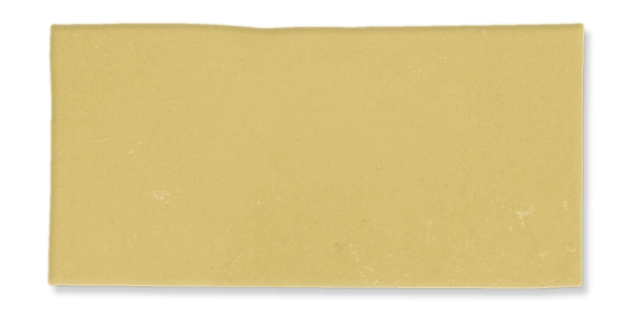 A single uncooked lasagna noodle sheet, rectangular in shape with a smooth, pale yellow surface, isolated on a white background.