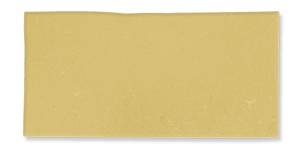 A single uncooked lasagna noodle sheet, rectangular in shape with a smooth, pale yellow surface, isolated on a white background.