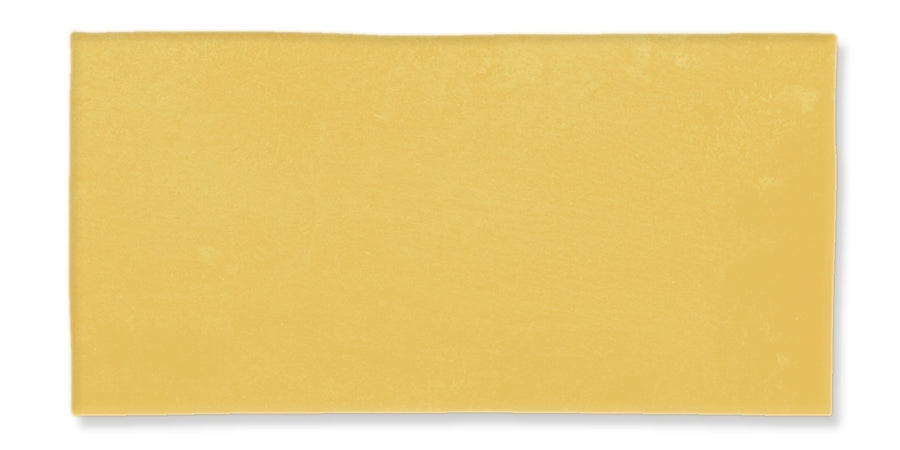 A single, rectangular slice of yellow cheese shown against a white background.