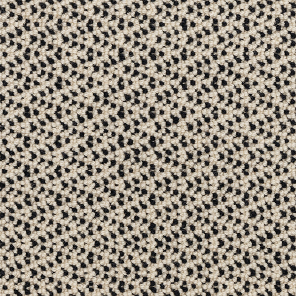 Close-up of the Fretwork On Trend Carpet in Mystic Fog, featuring a textured woven fabric with a repeating pattern of black and off-white threads. This small geometric, polka-dot-like design is reminiscent of classic geometric patterns, while the carpet’s durable construction ensures lasting style and longevity in any setting.