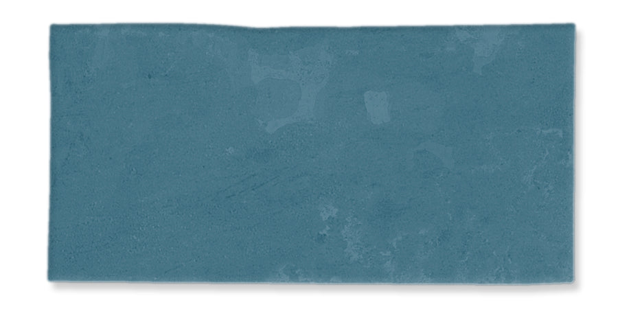 A rectangular slab of textured blue-green material with subtle variations in color and slightly uneven edges, set against a white background.