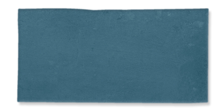 A rectangular slab or tile with a rough, textured surface in a muted blue color, set against a white background.