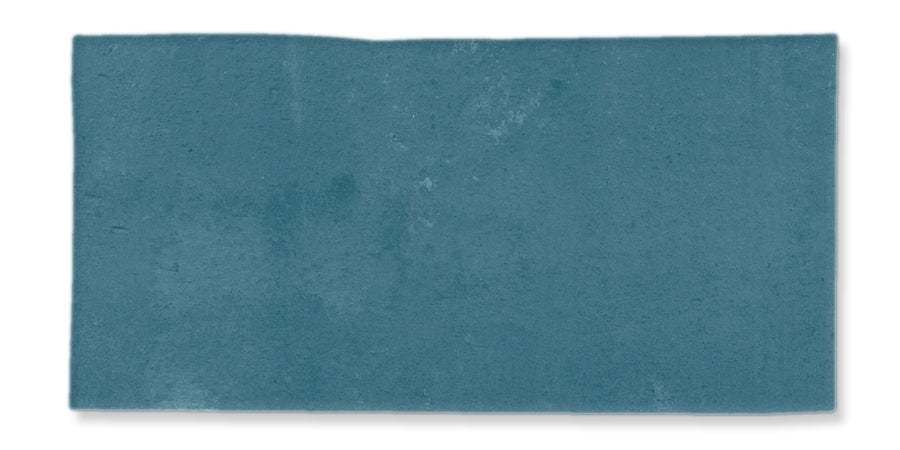 A rectangular piece of textured, blue paper with uneven edges against a white background.