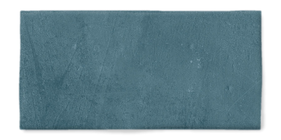 A rectangular teal tile with a matte, slightly textured surface against a white background.