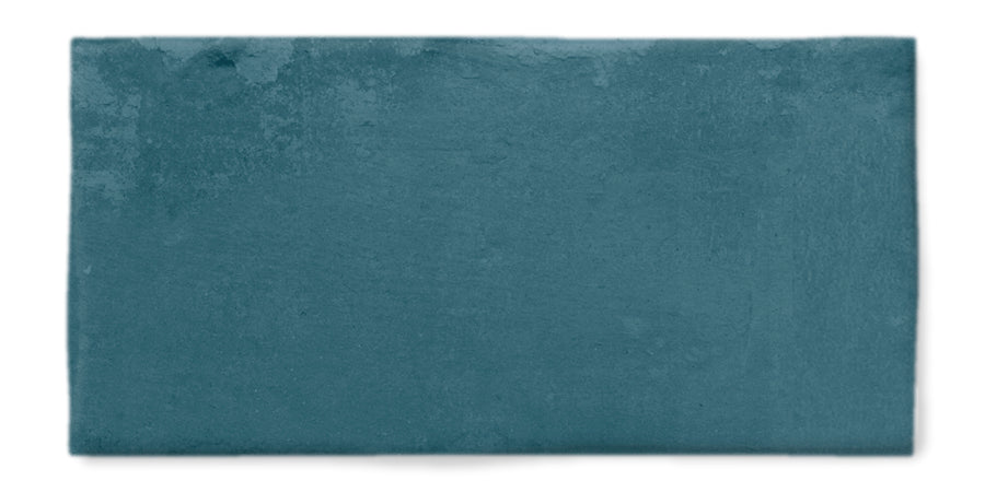 A rectangular teal ceramic tile with a slightly uneven surface and subtle variations in texture, displayed on a white background.