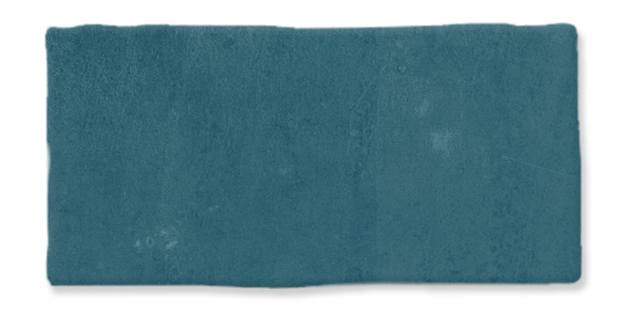 A rectangular, teal-colored swatch of fabric with a slightly uneven texture and soft, velvety appearance, set against a white background.