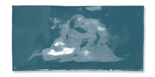 A rectangular blue-green abstract image with lighter and darker areas, suggesting indistinct shapes and forms, and a soft, textured appearance.