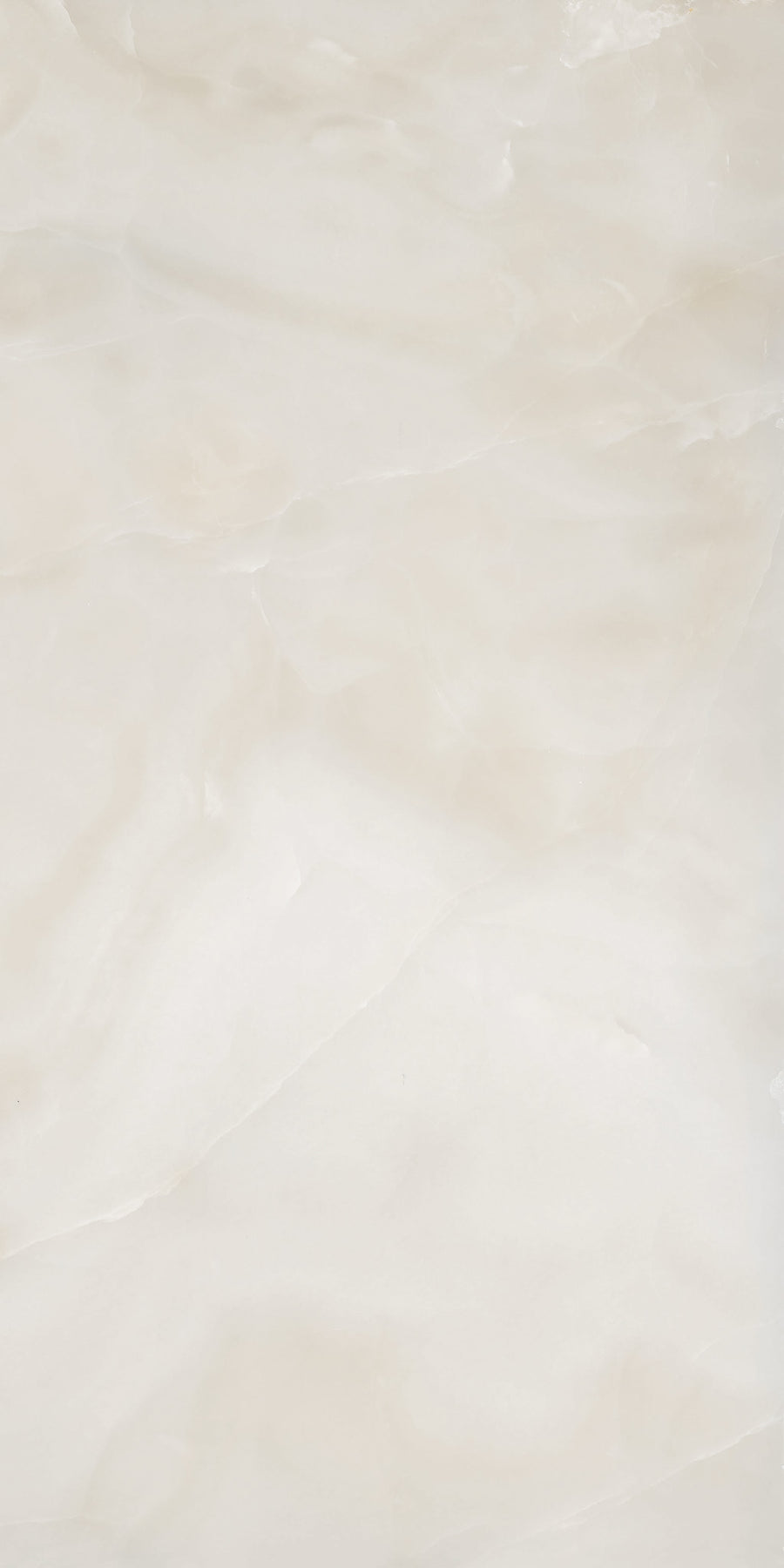 A smooth, off-white marble surface with subtle, wavy light beige and cream veins and cloudy patterns throughout, giving it a soft, natural, and polished appearance.