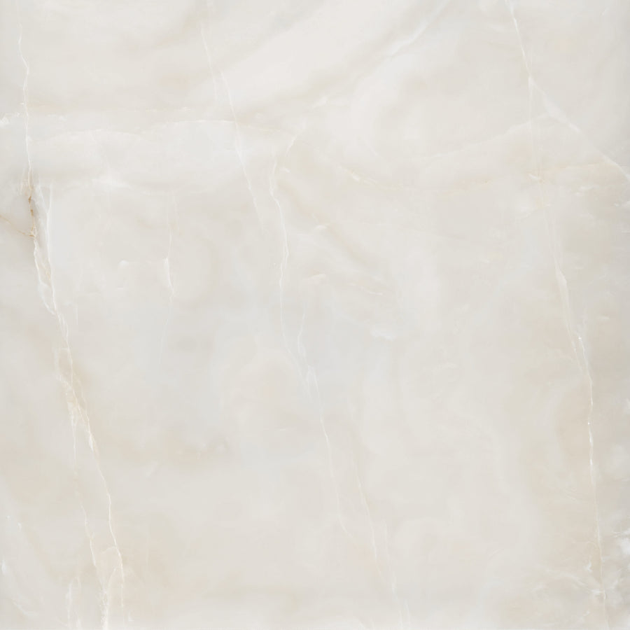 A smooth, light beige marble surface with subtle white and tan veining and soft, cloudy patterns throughout.
