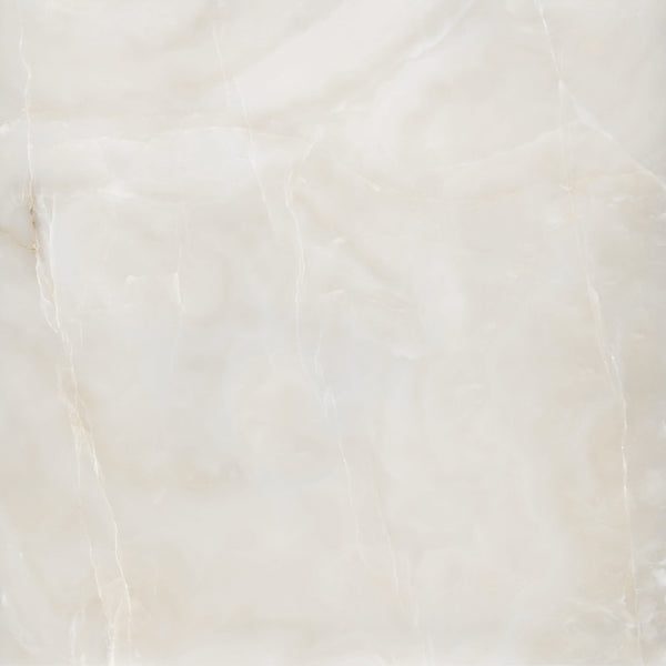 A close-up view of a light beige marble surface with soft, cloudy patterns and subtle white and cream veining throughout. The texture appears smooth and polished.