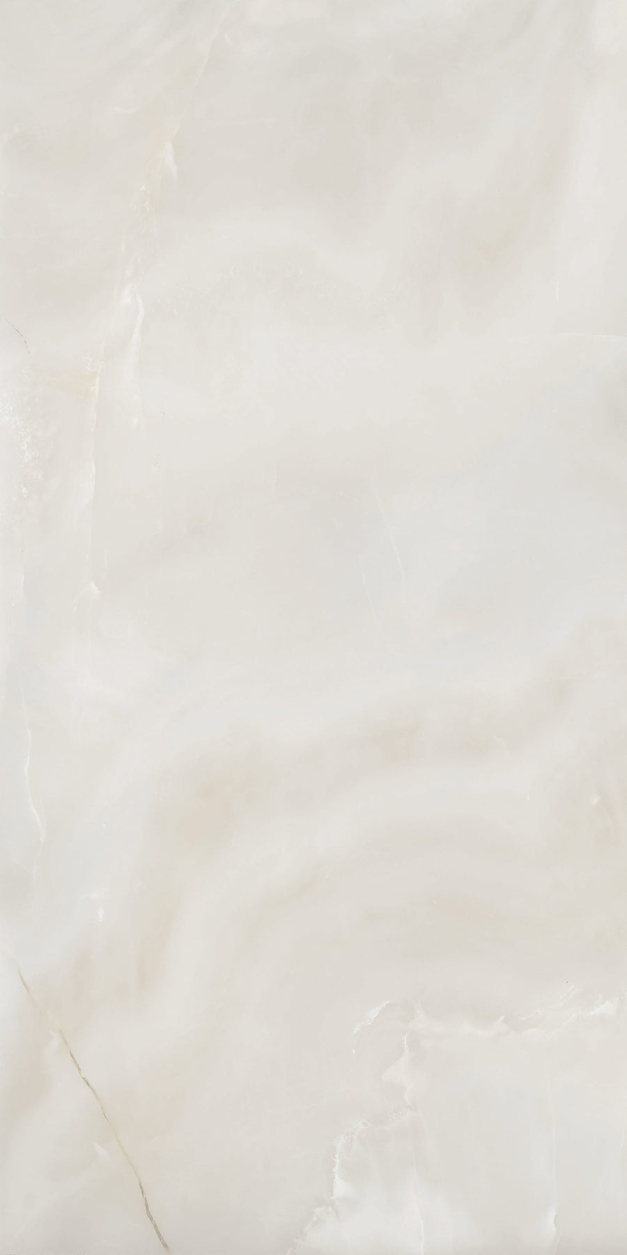 A close-up of a smooth, light beige marble surface with subtle, wavy white and cream-colored veins and patterns throughout.
