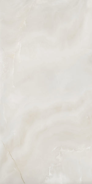 A close-up view of a smooth, light beige marble surface with subtle white and cream swirls and faint natural veining throughout.