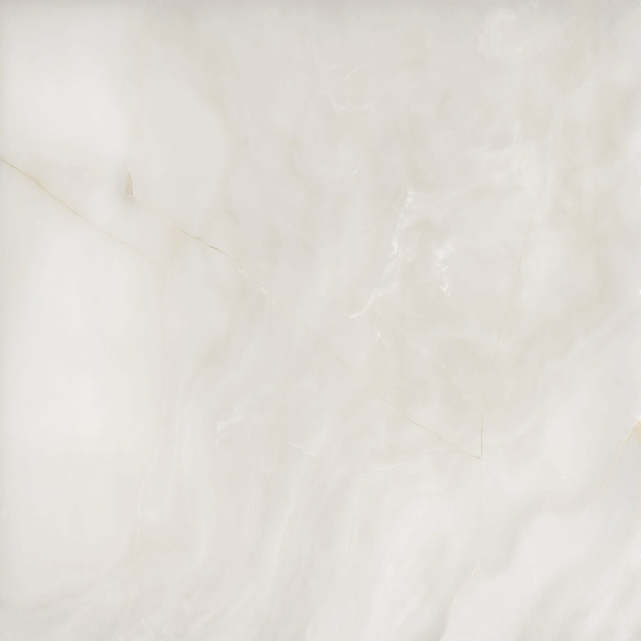 White marble surface featuring soft, cloudy patterns and subtle beige and gray veining, giving a smooth and elegant appearance.