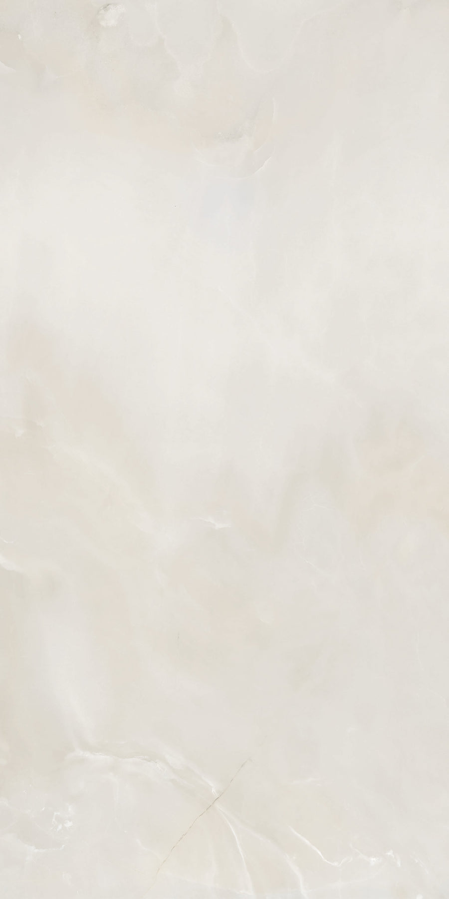 A smooth, light beige marble surface with subtle white and cream veining, creating a soft, cloudy pattern across the stone.